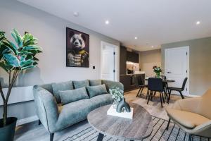 a living room with a couch and a table at 2 Bedroom Apartment Leeds City Centre - Free Parking in Leeds