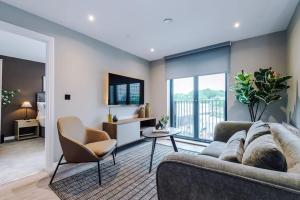 a living room with a couch and a table at 2 Bedroom Apartment Leeds City Centre - Free Parking in Leeds