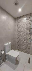 a bathroom with a toilet and a shower at Happiness City in Iskele +43 photos