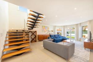 un soggiorno con una scala e un divano di GuestReady - Sunshine oasis with pool ad Azeitao