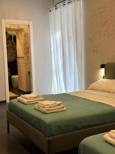 a bedroom with a bed with two folded towels on it at A casa da mario in Naples