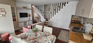 a kitchen and dining room with a table and a staircase at Casa da Avo Ilda - Near the Sea in Matosinhos