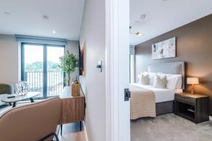 a bedroom with a bed and a balcony at Stylish Leeds City Centre Flat - Free Parking in Leeds +78 photos