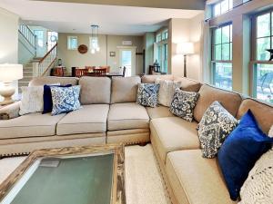 a living room with a large couch with blue pillows at Acorn Cottage in Oakland