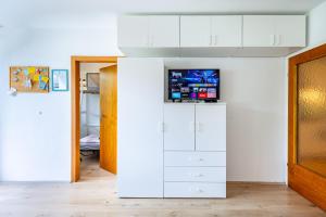 TV a/nebo společenská místnost v ubytování MOOKI Beach Apartment