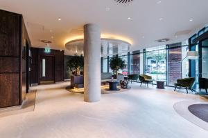 a lobby with a column in the middle of a building at Stylish Leeds City Centre Flat - Free Parking in Leeds