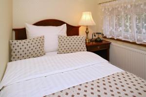 Ένα ή περισσότερα κρεβάτια σε δωμάτιο στο Hotel MERTIN