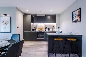 a kitchen and dining room with a table and chairs at Premium 3 Bed Apartment City Centre - Free Parking in Leeds +74 photos