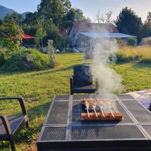 a grill with a bunch of hot dogs on it at übernachtung in unserem Wohnwagen in Gračac +16 photos