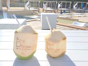 two slices of watermelons on a table near a pool at Blue dream Hamaca in Grand-Bourg