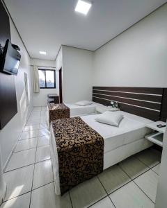 Postel nebo postele na pokoji v ubytování Papagaio Hotel