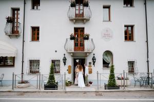 a bride and groom standing in front of a building at Hotel Casa Pavesi in Grinzane Cavour