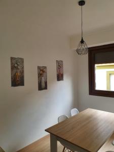 a dining room table with four pictures on the wall at Sol in Cangas de Morrazo +8 photos