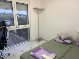 a bedroom with a bed and a large window at Apartment Ajdarpasic in Bar