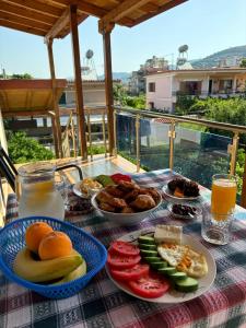 een tafel met borden eten bovenop een tafel bij Villa Berat - View of Berat Castle & Traditional Breakfast in Berat