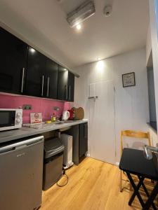 a kitchen with black and white cabinets and a table at Market 4 in Galway