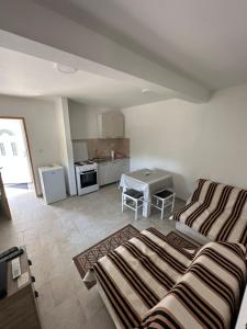 a living room with a bed and a kitchen at Apartman Sofija HN in Herceg-Novi