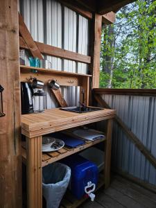 a sink in an outdoor kitchen in a log cabin at Zest Campers Ltd in Golden