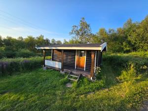 a small cabin in the middle of a field at Tana Familiecamping in Tana +24 photos