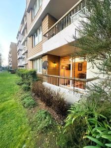 a large apartment building with a porch in a yard at Condominio Jardín de los robles Osorno in Osorno