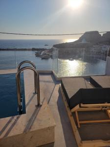 a bathroom with a view of the ocean on a house at Almyra Boutique Suites with Private Pool -Finiki in Foinikion