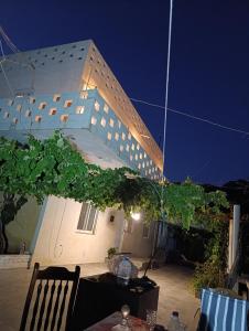 a building with a table and chairs in front of it at NIKOLARI RESORTs in Himare +7 photos