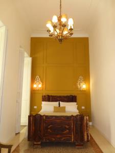 a bedroom with a large bed with a chandelier at Casa Orlanda in Naples +47 photos