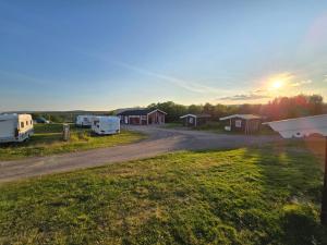 a view of a campground with the sunset in the background at Tana Familiecamping in Tana