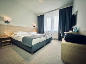 Posteľ alebo postele v izbe v ubytovaní Hotel Turkus