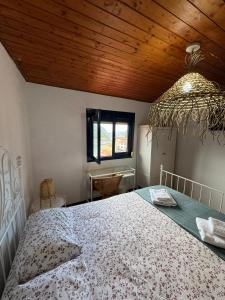 a bedroom with a bed and a wooden ceiling at Casa de pescadores con vistas al mar in Cudillero