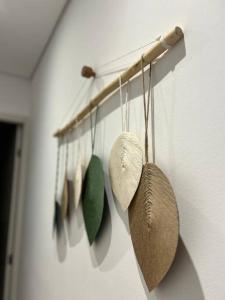 a group of kitchen utensils hanging on a wall at Chalé Container - Luxo Rústico in Ibiúna