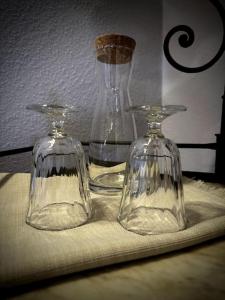 two glass vases sitting on a table with a table cloth at La Sesta Luna in Pienza +12 photos