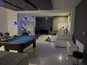 a living room with a pool table in it at Casa Concept Delicias in Delicias