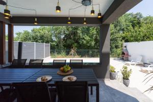 an outdoor dining area with a table and chairs at Villa Maša in Rovinj