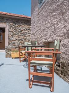a group of chairs sitting next to a building at Traditional Stone Villa 1 in Ellinikón