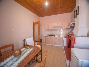 a kitchen and dining room with a table and a dining room at Traditional Stone Villa 1 in Ellinikón