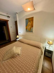 una camera da letto con un letto e un quadro sul muro di L'affittacamere nel parco "Appia antica" - Piscina a uso ospiti a Roma Altre 28 foto