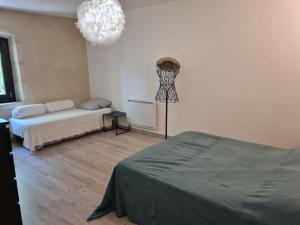 a bedroom with a bed and a dress on a dummy at Partie de mas en campagne in Eyragues