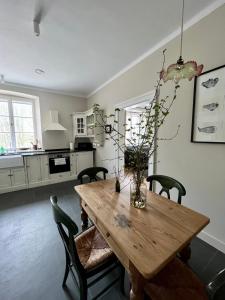 a dining room with a wooden table and chairs at Appartment II Dwor Kuflew in Mrozy +20 photos