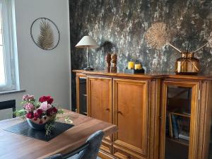 a room with a wooden table with a vase of flowers at Wohnung in Stadtvilla, Dessau-Ziebigk in Dessau