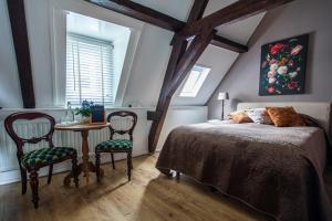 a bedroom with a bed and a table and chairs at B&B De zilveren reiger in Middelburg +33 photos