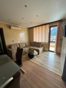 a living room with a couch and a table at Amazing View Apartment in Vratsa