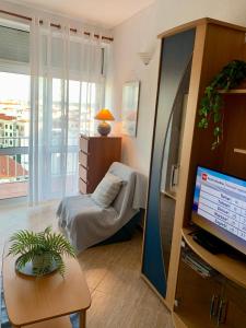 a living room with a tv and a couch and a chair at Apartment 505 in São Martinho do Porto +54 photos