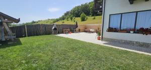 a backyard with tables and chairs and a fence at Cezar House in Codlea +2 photos