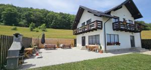 a house with a patio with tables and chairs at Cezar House in Codlea