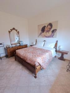 Postel nebo postele na pokoji v ubytování B&B Il Melograno
