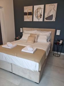 a large bed with two towels on top of it at Villa Klara in Privlaka +8 photos