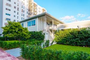 an apartment building with a garden in front of it at The West Gem in Miami Beach