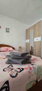 a bedroom with two beds with butterflies on the bedspread at Casa Melcilor in Mangalia