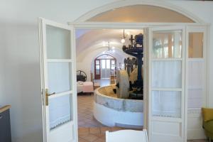 a room with a tub in the middle of a room at FRANTOIO NONNA VALERIA in Diso +34 photos